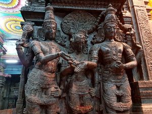 Vishnu (left) gives away his sister and bride Meenakshi's hand into the waiting hand of groom Shiva
